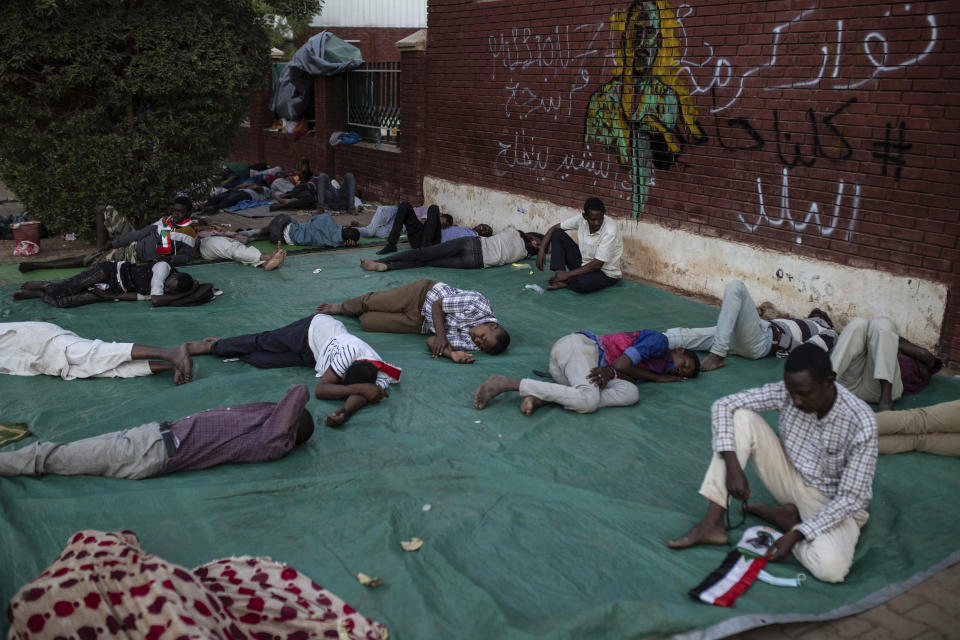 Protesters rest during a sit-in inside the Armed Forces Square, in Khartoum, Sudan, Wednesday, April 17, 2019. A Sudanese official and a former minister said the military has transferred ousted President Omar al-Bashir to the city's Kopar Prison in Khartoum. The move came after organizers of the street protests demanded the military move al-Bashir to an official prison. (AP Photos/Salih Basheer)