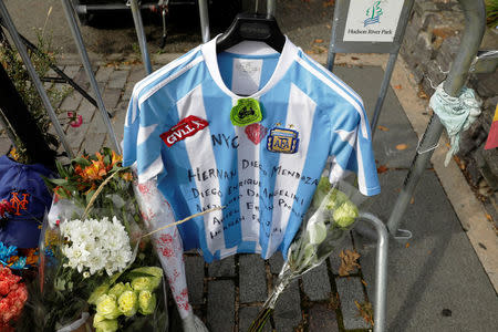 An Argentinian national team jersey hangs at a memorial on West Street two days after a man driving a rented pickup truck mowed down pedestrians and cyclists on a bike path alongside the Hudson River, in New York, U.S., November 2, 2017. REUTERS/Lucas Jackson