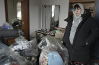 Halina Panasian, 69, reacts inside her destroyed house after a Russian rocket attack in Hlevakha, Kyiv region, Ukraine, Thursday, Jan. 26, 2023. (AP Photo/Roman Hrytsyna)