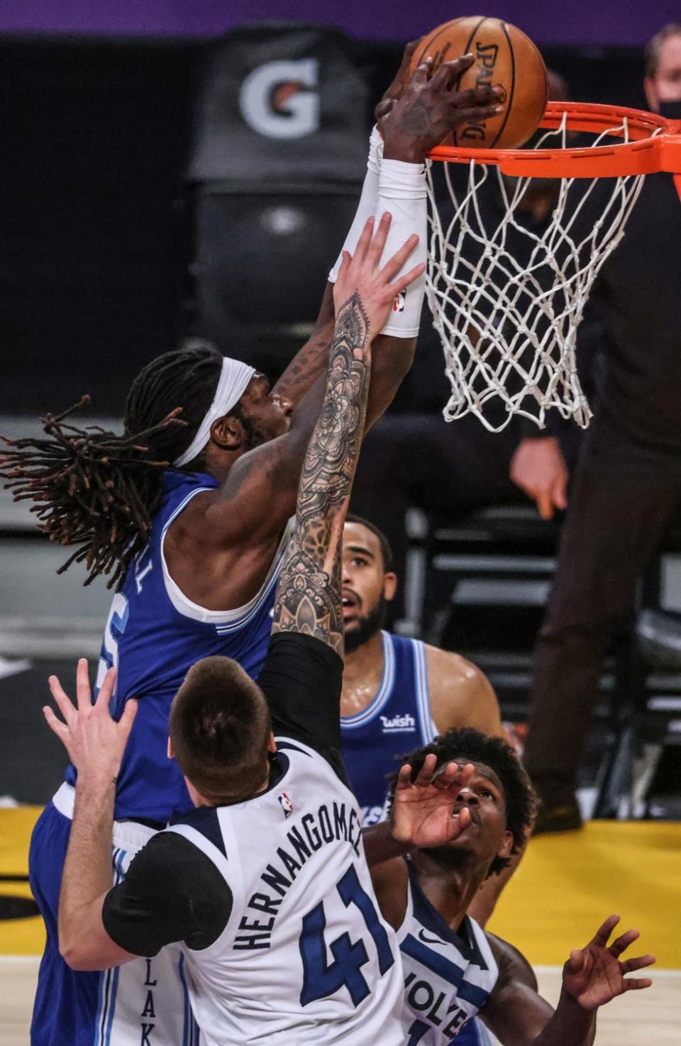 Lakers center Montrezl Harrell slam dunks over Minnesota Timberwolves forward Juancho Hernangomez.