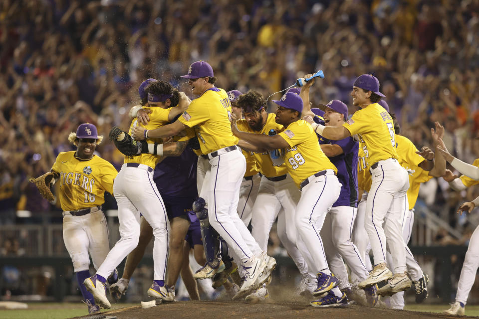 LSU closer Gavin Guidry, left, hugs teammates after defeating Florida in Game 3 of the NCAA College World Series baseball finals in Omaha, Neb., Monday, June 26, 2023. LSU won the national championship 18-4. (AP Photo/Rebecca S. Gratz)