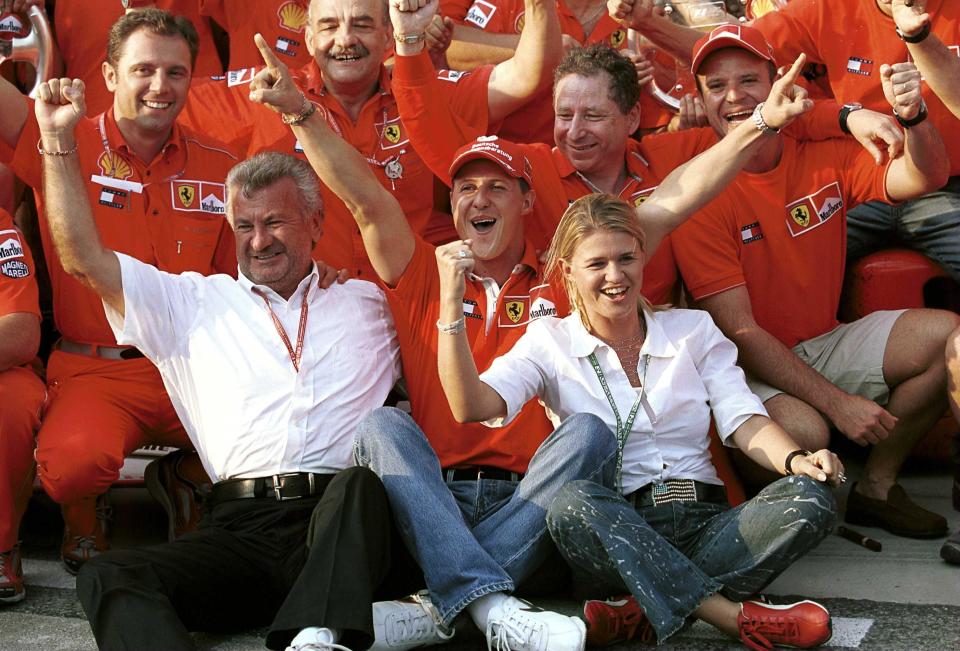 Michael Schumacher celebrates with his wife Corrina team boss Jean Todt, Manager Willi Weber, and Rubens Barrichello after clinching the World Championship with his win in Hungary