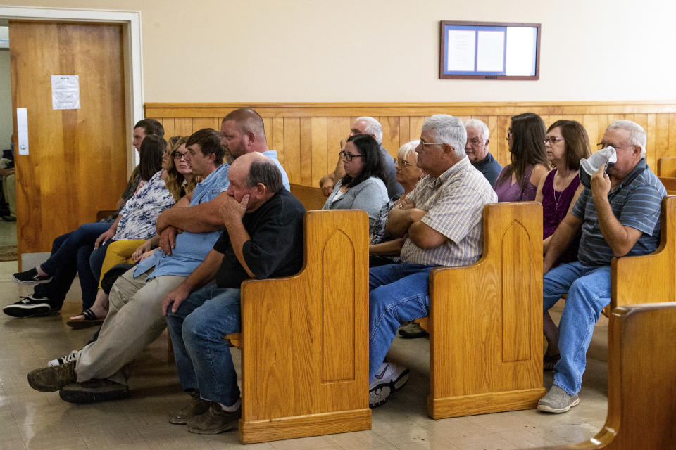 People gather to watch Kirby Gene Wallace's first appearance at the Stewart County Courthouse Tuesday, Oct. 9, 2018, in Dover, Tenn. Wallace, a multiple-murder suspect who led Tennessee law enforcement on an intense 7-day manhunt was captured without a struggle Friday morning, Oct. 5, in a wooded area about two hours northwest of Nashville. Wallace was wanted in two counties on charges that include murder, arson and kidnapping. (Courtney Pedroza/The Tennessean via AP, Pool)