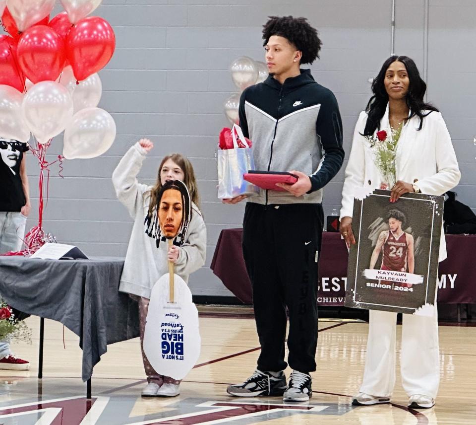 Worcester's Kayvaun Mulready takes center court with his mother, Trafficia Warburton, and one of his biggest fans, Raeya O'Keefe, on Senior Night for the Worcester Academy boys' basketball team.