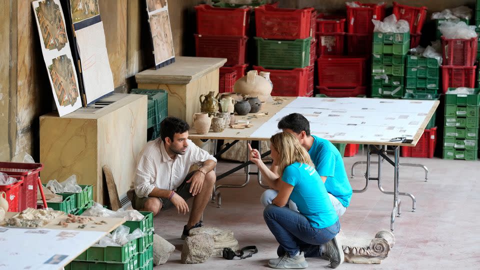 Archaeologists work on findings coming from the excavation site of the ancient Roman emperor Nero's theater. - Andrew Medichini/AP