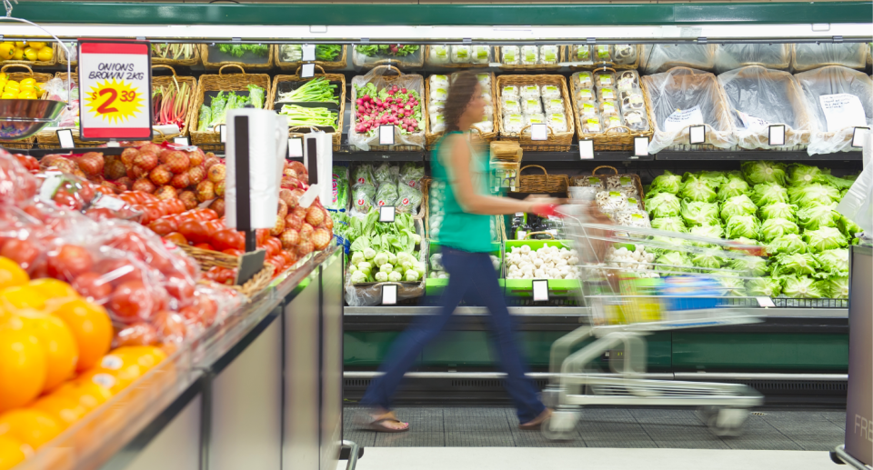 woman pushing trolley in supermarket