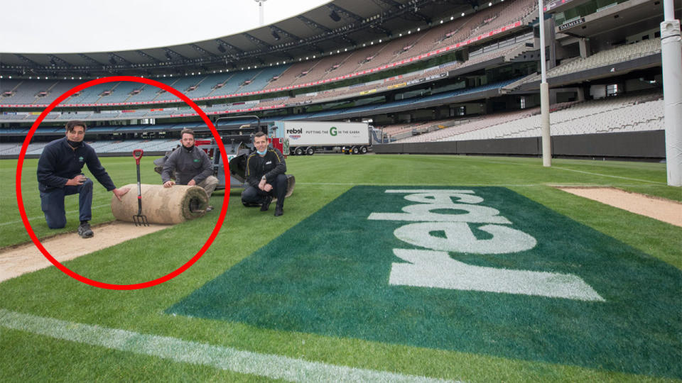 MCG curators can be seen here rolling up part of the turf to be transported to Brisbane.