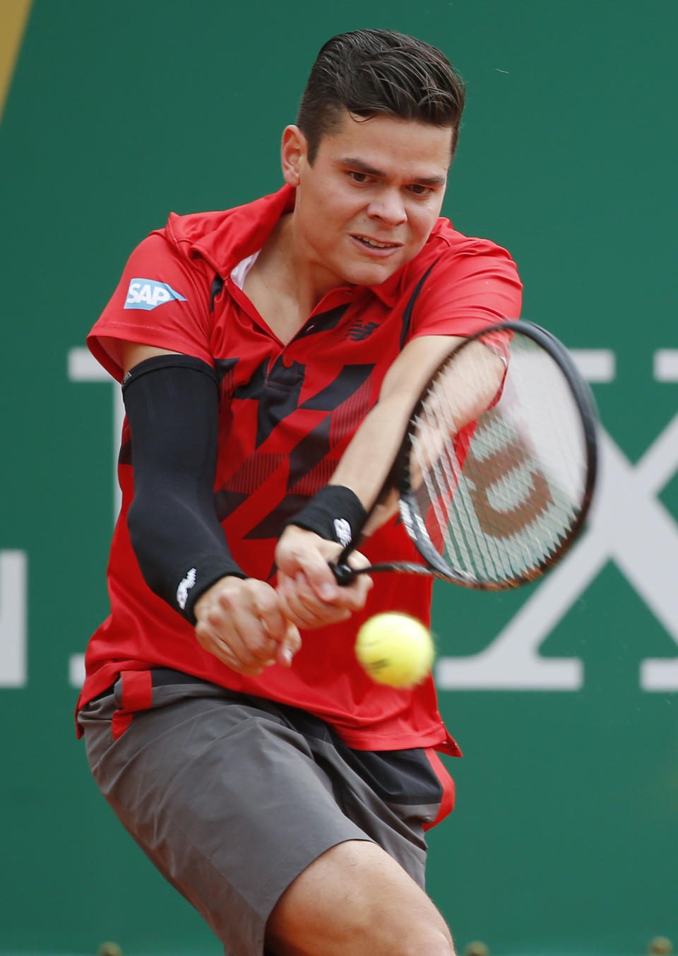 Milos Raonic of Canada returns the ball to Yen-Hsun Lu of Taiwan during their match of the Monte Carlo Tennis Masters tournament in Monaco, Wednesday, April 16, 2014. (AP Photo/Michel Euler)