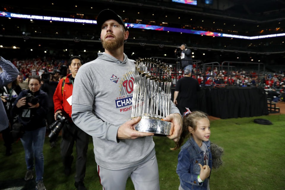 HOUSTON, TX - OCTOBER 30:  Stephen Strasburg #37 of the Washington Nationals celebrates with the Commissioner's Trophy after the Nationals defeated the Houston Astros in Game 7 to win the 2019 World Series at Minute Maid Park on Wednesday, October 30, 2019 in Houston, Texas. (Photo by Rob Tringali/MLB Photos via Getty Images)