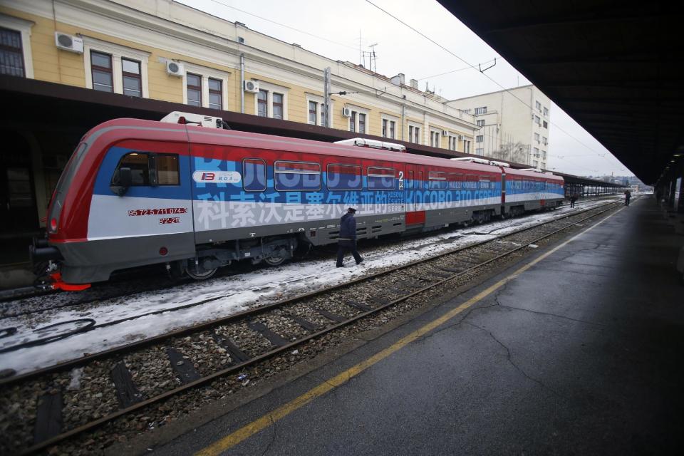 A railroad worker walks by the first train decorated with letters that read "Kosovo is Serbian" written in twenty languages departing from the Belgrade to Mitrovica, Kosovo at Belgrade's railway station, Serbia, Saturday, Jan. 14, 2017. Serbia has launched a railway link to Serb-dominated northern Kosovo despite protests from authorities in Pristina who described the move as a provocation and an aggressive violation of Kosovo's sovereignty. (AP Photo/Darko Vojinovic)