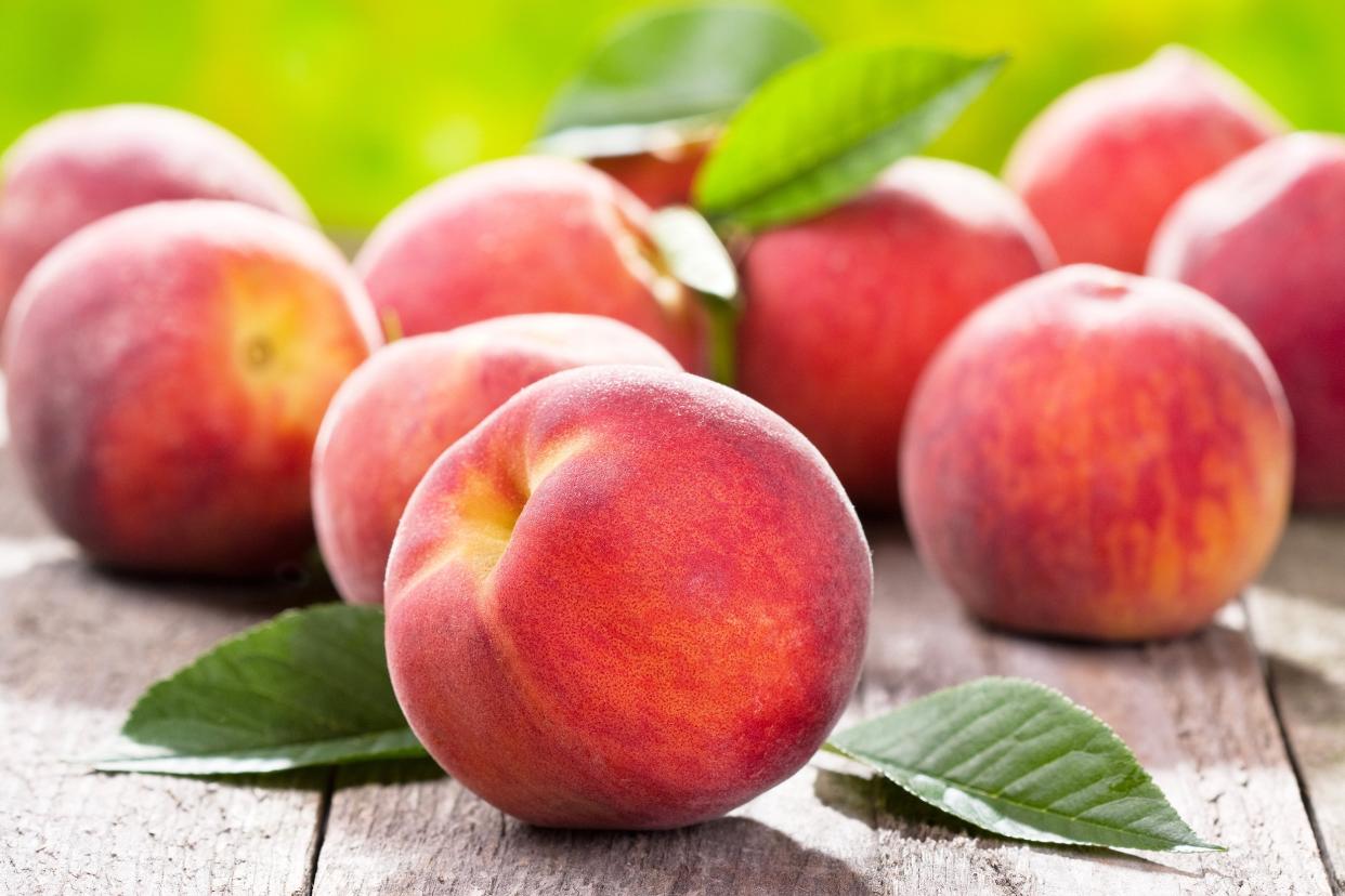 fresh peaches on wooden table