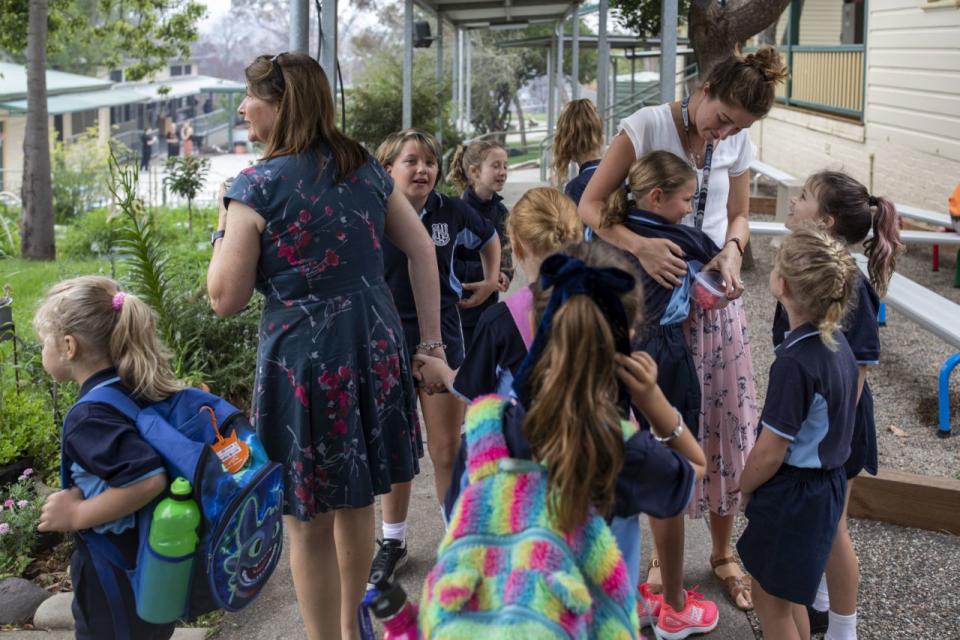 Pictured are students at school wearing backpacks. 