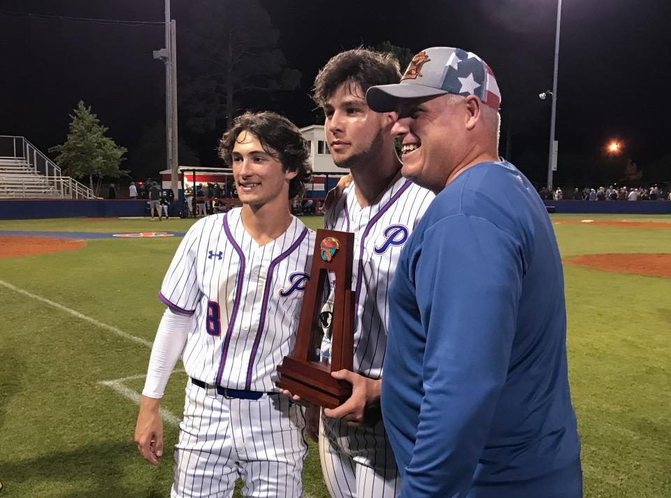 The Patriots pose with the trophy after winning the Tate vs Pace 6A District 1 championship baseball game at Pace High School on Thursday, May 5, 2022.