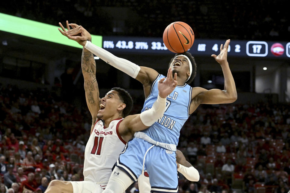 Arkansas forward Jalen Graham (11) and Old Dominion guard Vasean Allette (0) fight for a rebound during the first half of an NCAA college basketball game Monday, Nov. 13, 2023, in Fayetteville, Ark. (AP Photo/Michael Woods)