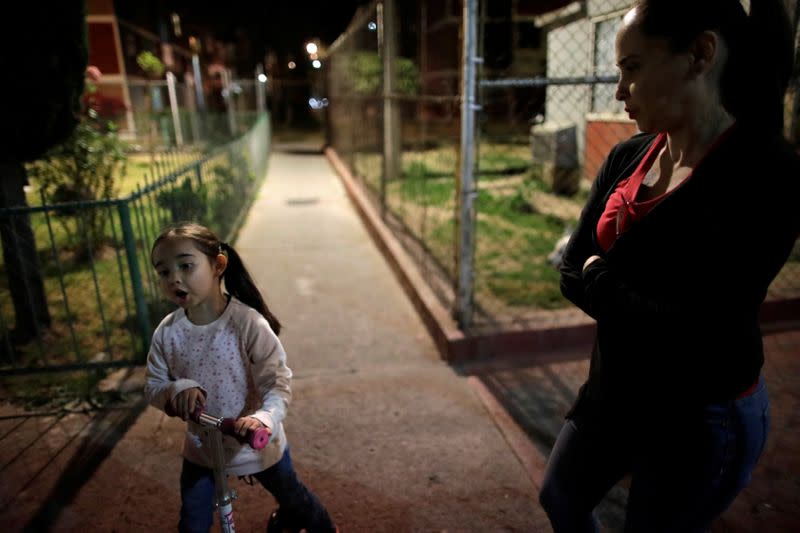 Diana Paula Melo speaks to her mother, Monica Marquez, as she rides a scooter in her neighbourhood in Mexico City