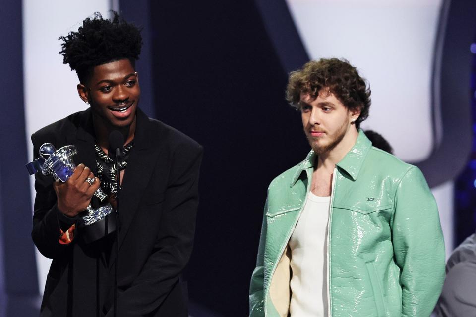 Lil Nas X and Jack Harlow accept an award onstage at the 2022 MTV VMAs