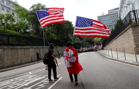 Protesters hold U.S. flags during a march to the U.S. Consulate General in Hong Kong