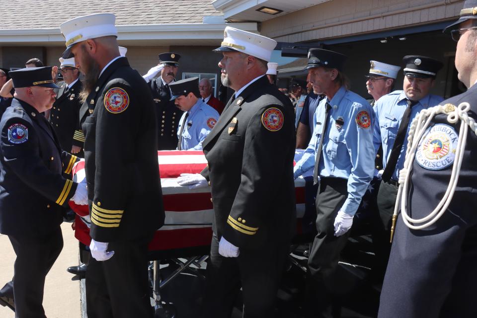 Members of the Fritch Volunteer Fire Department carry Fire Chief Zeb Smith from Grace Church in Borger after a memorial service Saturday. He was placed on the top of a firetruck to be laid to rest in Westlawn Memorial Park just outside of Fritch. Smith suffered a medical emergency and died while fighting a fire Tuesday, after spending days fighting wildfires burning across the Texas Panhandle.