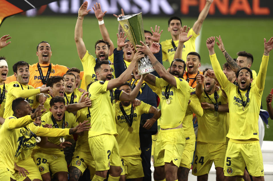 Villarreal players celebrate with trophy after winning the Europa League final soccer match between Manchester United and Villarreal in Gdansk, Poland, Wednesday May 26, 2021. (Maja Hitij, Pool via AP)