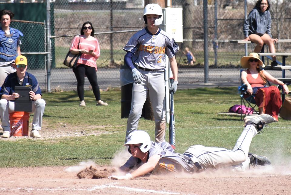 Trey Murnane dives across home plate at Soldiers and Sailors Park in St. Johnsville Thursday, scoring a run in the Utica-Notre Dame Jugglers' 14-12 win over Oppenheim-Ephratah-St. Johnsville/Dolgeville.