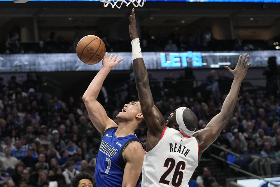 Dallas Mavericks center Dwight Powell (7) shoots against Portland Trail Blazers center Duop Reath (26) during the first half of an NBA basketball game in Dallas, Friday, Jan. 5, 2024. (AP Photo/LM Otero)