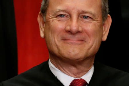 FILE PHOTO: U.S. Chief Justice John Roberts participates in taking a new family photo with his fellow justices at the Supreme Court building in Washington, D.C., U.S., June 1, 2017. REUTERS/Jonathan Ernst/File Photo