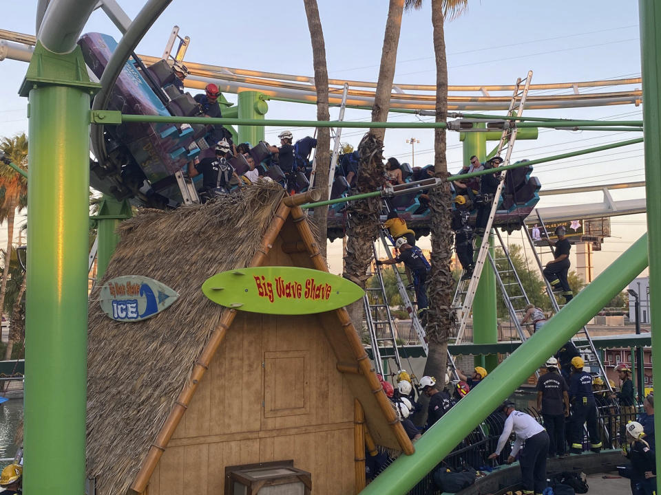 This photo provided by Glendale Fire Department responders rescuing people stuck on a roller coaster at Castles N’ Coasters on Saturday, May 15, 2021 in Phoenix. The Phoenix Fire Department said the ride got stuck Saturday, with riders perched 20 feet (six meters) off the ground. Rescue crews were dispatched and were able to escort 22 people off the ride safely. (Glendale Fire Department via AP)