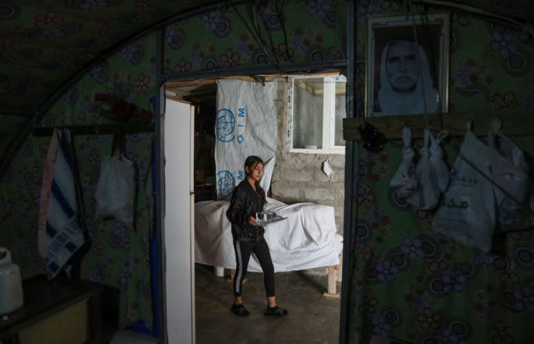 A displaced Yazidi girl walks in a tent at the Chamishko camp in the city of Zakho, where members of the community fled after a recent surge in violence (AFP/SAFIN HAMED)