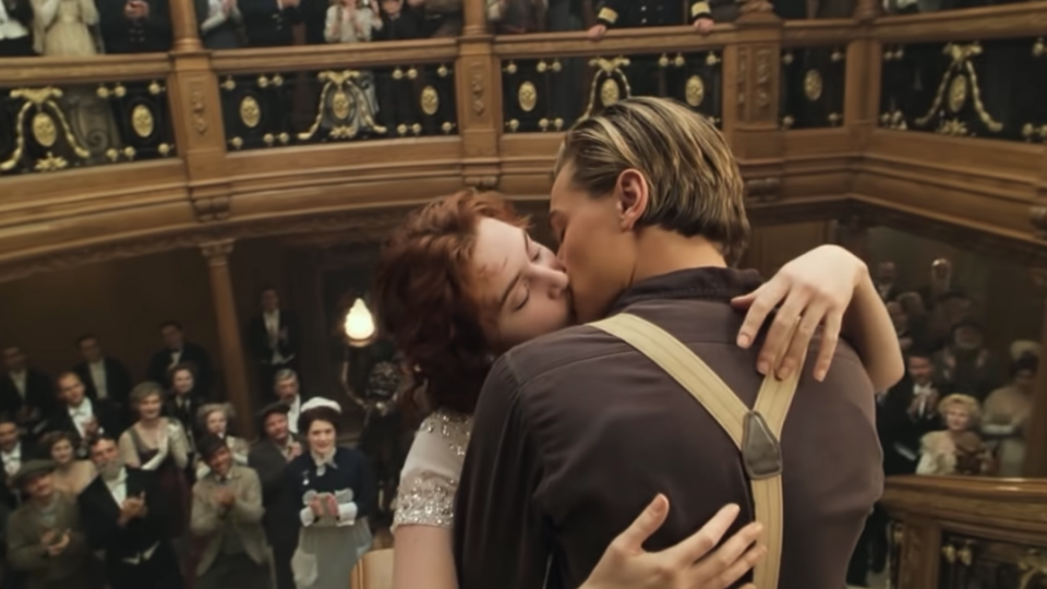 Jack and Rose kissing as the entire crew and passengers of the Titanic watch and clap