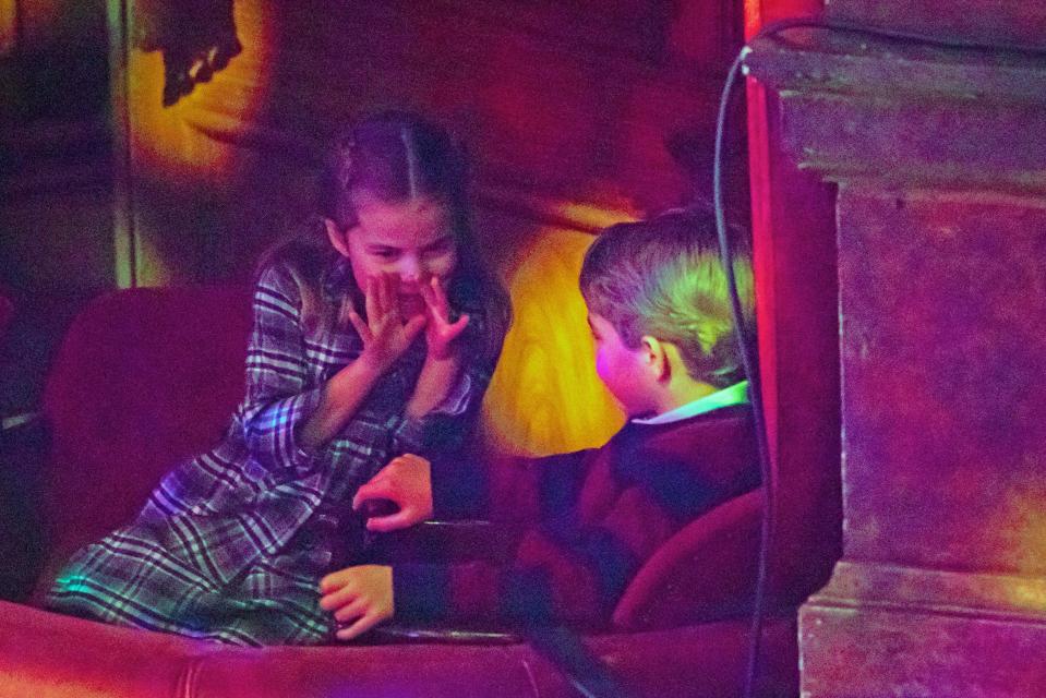 Britain's Princess Charlotte of Cambridge (L) speaks with her brother Britain's Prince George of Cambridge (R) during a special pantomime performance of The National Lotterys Pantoland  at London's Palladium Theatre in London on December 11, 2020, to thank key workers and their families for their efforts throughout the pandemic. (Photo by Aaron Chown / POOL / AFP) (Photo by AARON CHOWN/POOL/AFP via Getty Images)