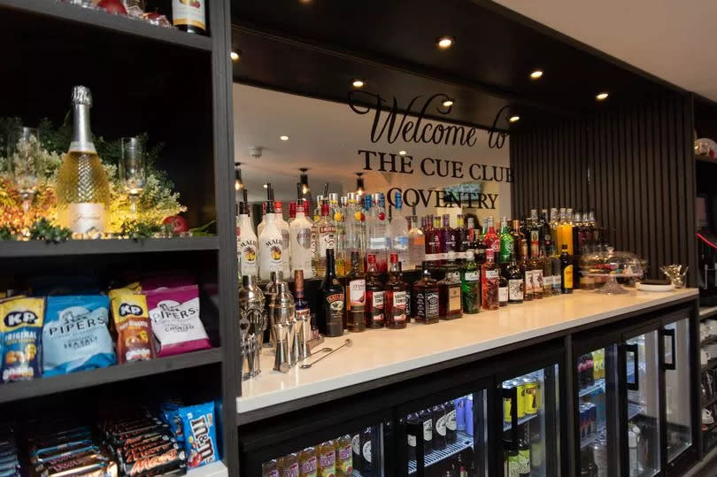 Members can enjoy refreshing drinks from the bar area while playing snooker, darts, or pool.