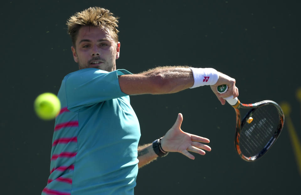 Stan Wawrinka, of Switzerland, follows through on a return to Roger Federer, of Switzerland, during the men's final at the BNP Paribas Open tennis tournament, Sunday, March 19, 2017, in Indian Wells, Calif. (AP Photo/Mark J. Terrill)