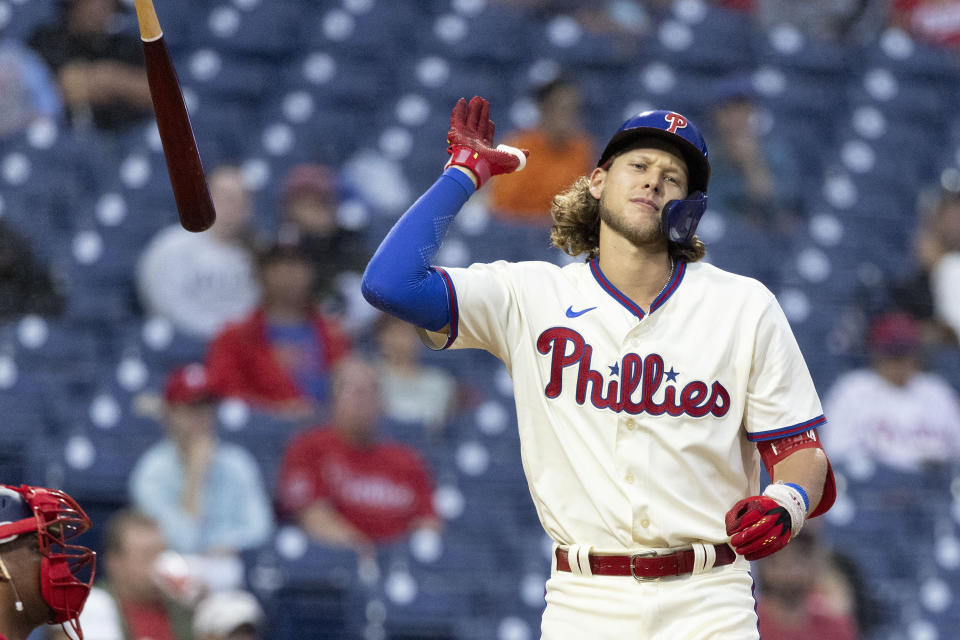 Philadelphia Phillies' Alec Bohm throws his bat after striking out in the third inning of a baseball game against the Washington Nationals, Sunday, Sept. 11, 2022, in Philadelphia. (AP Photo/Laurence Kesterson)