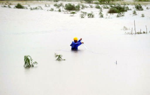 A local resident fishes in flood waters in Suao, eastern Ilan county, as typhoon Saola approches Taiwan's east coast on August 2, 2012. Authorities evacuated nearly 600 residents from New Taipei City in the north and as many from the eastern counties of Ilan and Hualien, which look set to bear the brunt of the typhoon