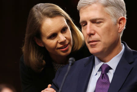 Supreme Court nominee judge Neil Gorsuch speaks with his wife Marie Louise during a break in his confirmation hearing before the Senate Judiciary Committee on Capitol Hill in Washington, U.S., March 21, 2017. REUTERS/Joshua Roberts