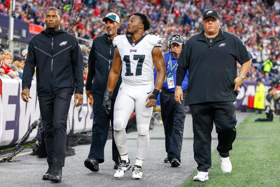 Philadelphia Eagles linebacker Nakobe Dean (17) is escorted off the field during the second half of an NFL football game against the New England Patriots, Sunday, Sept. 10, 2023, in Foxborough, Mass.