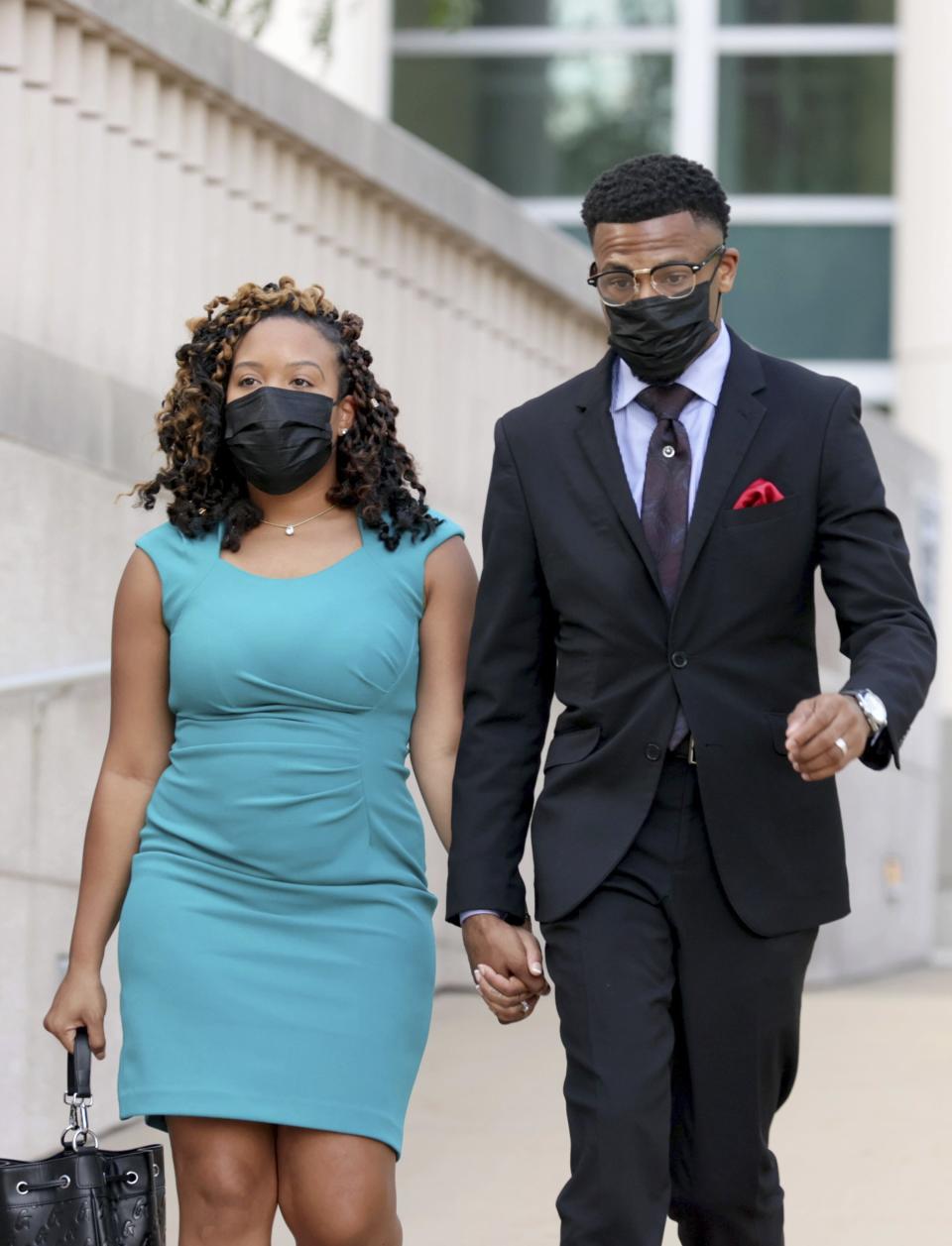 Former St. Louis Alderman John Collins-Muhammad leaves the Thomas Eagleton Federal Courthouse with his wife, Asia Collins-Muhammad, on Tuesday, Aug. 23, 2022, after pleading guilty in a federal corruption case, in St. Louis. (Christian Gooden/St. Louis Post-Dispatch via AP)