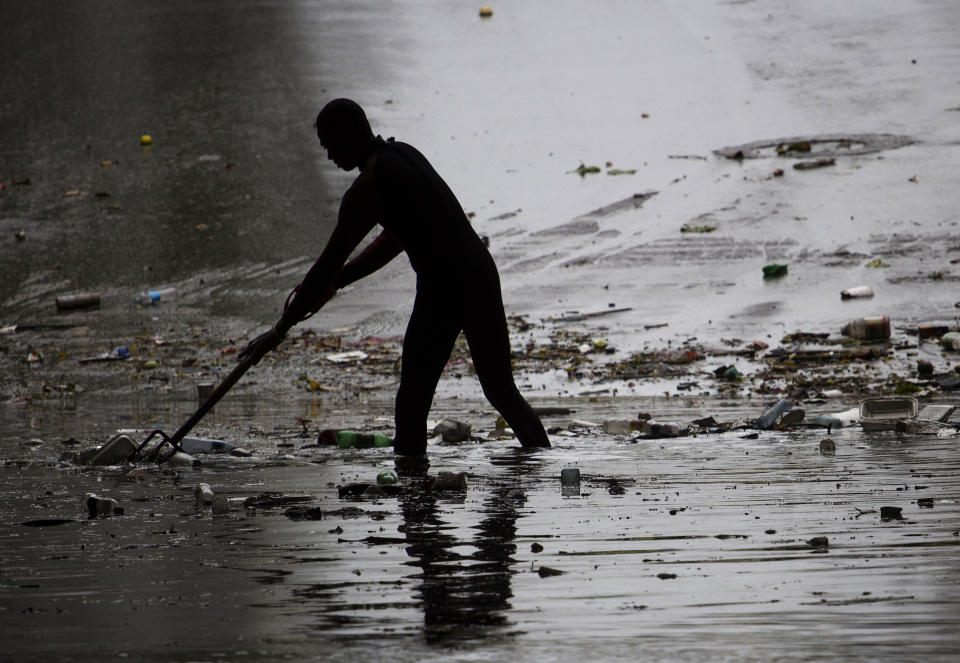 A firefighter helps clear a flooded street Oct. 25, 2012, after Hurricane Sandy swept through the nation.