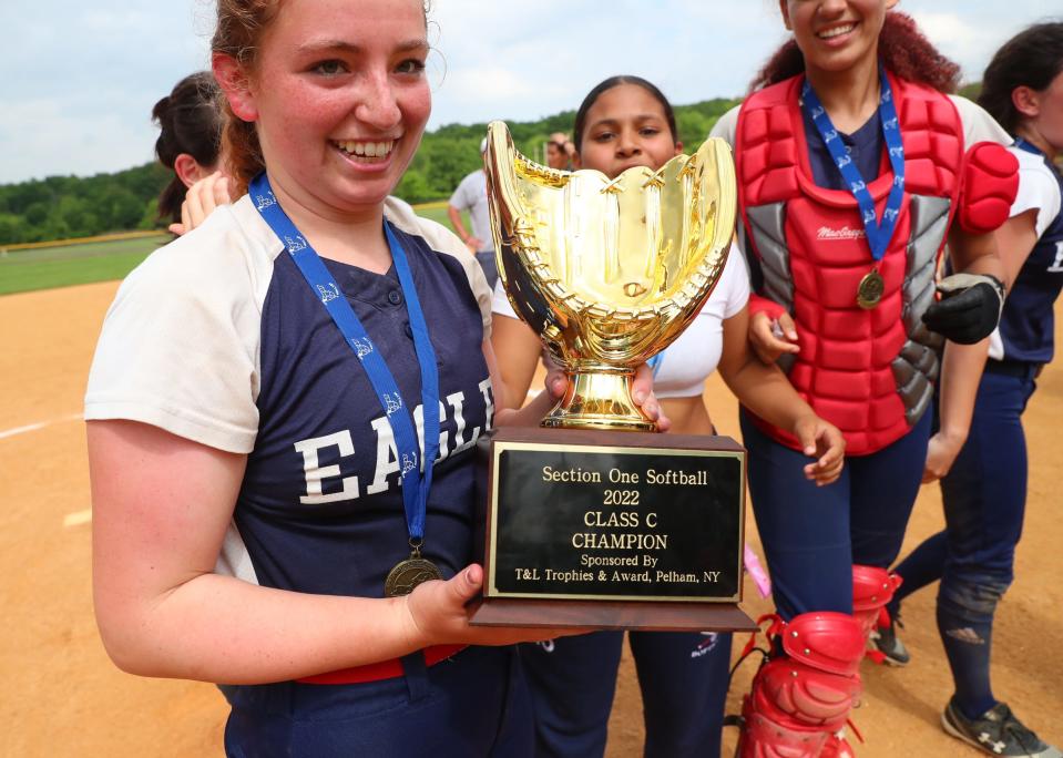 Yonkers Montessori Academy's Mackenzie Moccia (5) holds the championship trophy after defeating Tuckahoe 10-9 in the Class C softball championship game at North Rockland High School in Thiells, N.Y. on Friday, May 27, 2022.