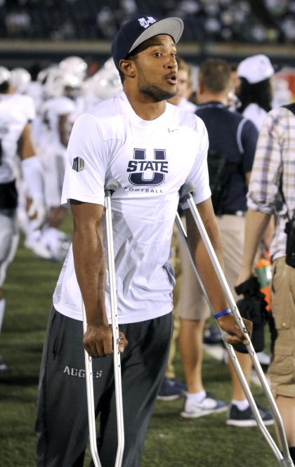 Utah State quarterback Chuckie Keeton stands on the sidelines after injuring his leg against Wake Forest during an NCAA football game, Saturday, Sept. 13, 2014, in Logan, Utah. (AP Photo/Eli Lucero)