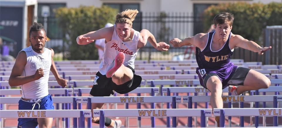 Wylie's Holden Atwood, right, and Lubbock-Cooper's Hayden Brooks, center, chase Abilene Cooper's Lawrence Diles in the 110 hurdles. Diles won in 14.37, followed by Atwood (14.73) and Brooks (14.89) at the District 4-5A track and field meet April 14 at Sandifer Stadium in Abilene.