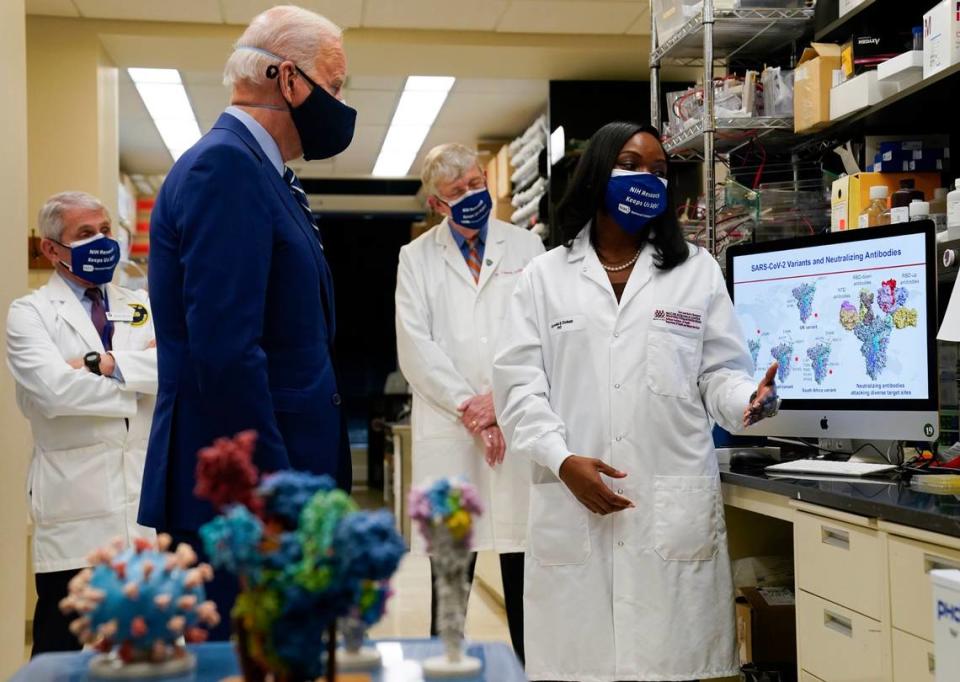 President Joe Biden listens as Kizzmekia Corbett, an immunologist with the Vaccine Research Center at the National Institutes of Health (NIH), right, speaks during a visit at the Viral Pathogenesis Laboratory at the NIH, Thursday, Feb. 11, 2021, in Bethesda, Md. From left, Dr. Anthony Fauci, director of the National Institute of Allergy and Infectious Diseases, left, Biden, NIH Director Francis Collins and Corbett.