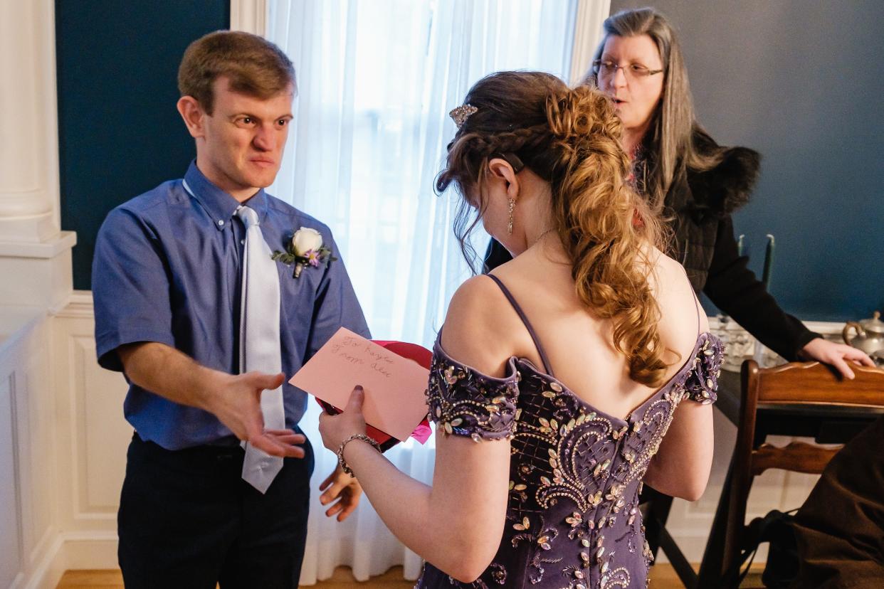 Alec Worth gives Kaylee Arthurs a gift of chocolates before the Night to Shine, a prom for people with special needs.