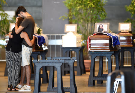 Coffins containing bodies of victims of the Genoa bridge collapse are seen at the Genoa Trade Fair and Exhibition Centre in Genoa, Italy August 17, 2018. REUTERS/Massimo Pinca