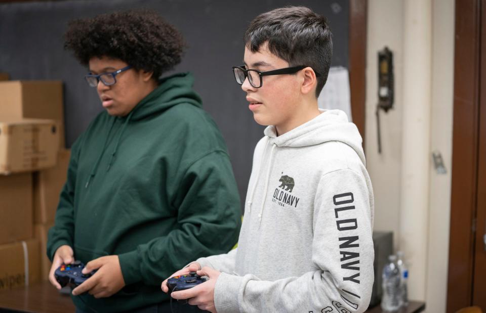 Southwest Detroit's Clippert Multicultural Magnet Honors Academy science students Marcus Barber, 14, and Andres Garay, 13, work together to drive and operate the team's robot as they prepare for an upcoming competition Tuesday, Nov. 22, 2022.