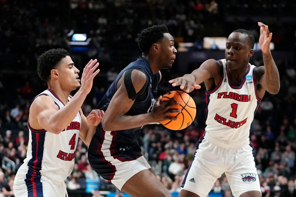 Mar 19, 2023; Columbus, Ohio, USA;  Florida Atlantic Owls guard Bryan Greenlee (4) and guard Johnell Davis (1) defend Fairleigh Dickinson Knights guard Joe Munden Jr. (1) during the second round of the NCAA men’s basketball tournament at Nationwide Arena. Mandatory Credit: Adam Cairns-The Columbus Dispatch