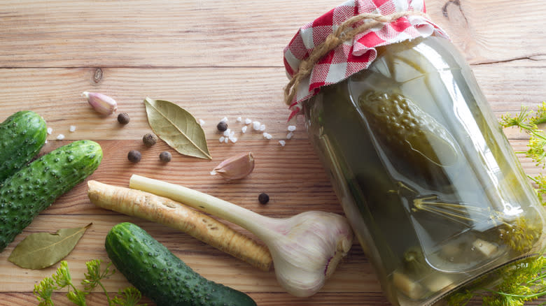 Jar of pickles with garlic, horseradish root, peppercorns