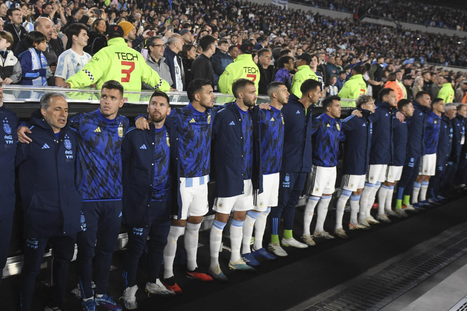 Argentina's Lionel Messi, third from right, embraces with teammates during the anthems prior to a qualifying soccer match for the FIFA World Cup 2026 against Paraguay at the Monumental stadium in Buenos Aires, Argentina, Thursday, Oct. 12, 2023. (AP Photo/Gustavo Garello)