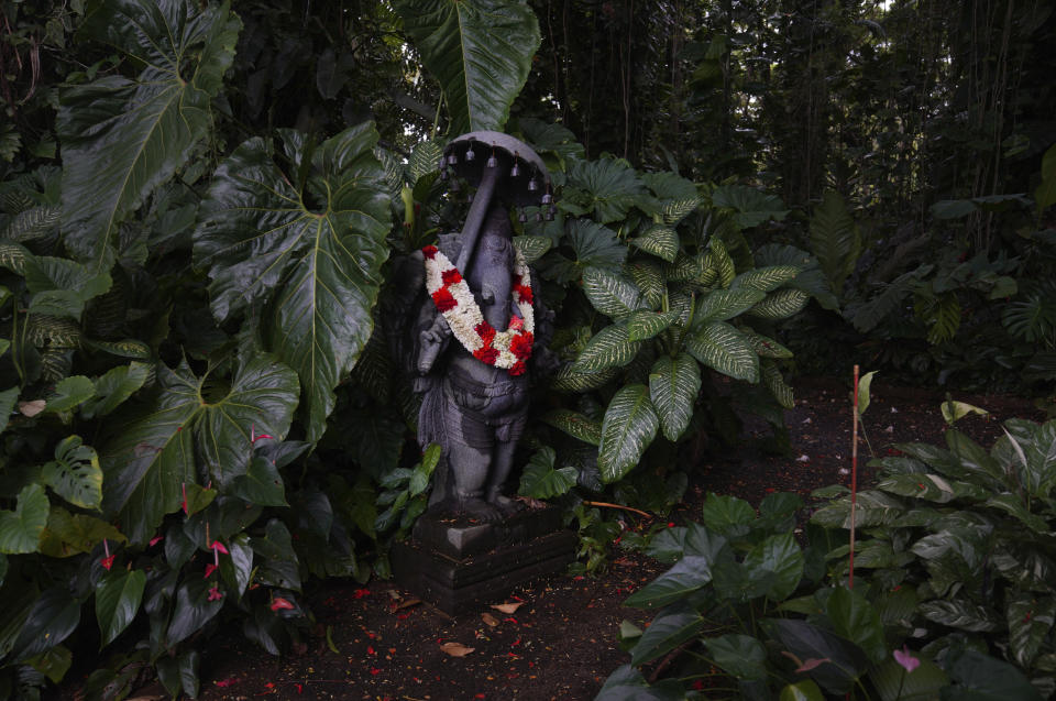 A statue of the Hindu god Ganesha stands in the forest of Kauai's Hindu Monastery on July 9, 2023, in Kapaa, Hawaii. (AP Photo/Jessie Wardarski)