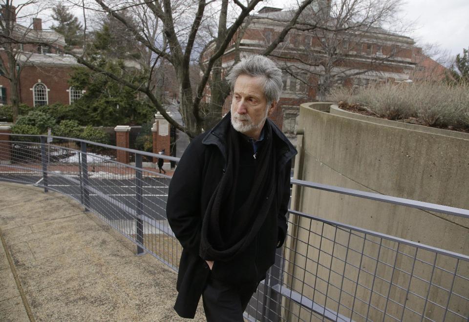 In this Monday, Jan. 27, 2014 photo, film professor Robb Moss, who has taught for twenty-five years at Harvard, walks outside the Carpenter Center for the Visual Arts on the school's campus in Cambridge, Mass, Mass. Three filmmakers nominated separately for this year’s Oscar for best feature documentary credit Moss for inspiring them to greatness. (AP Photo/Stephan Savoia)